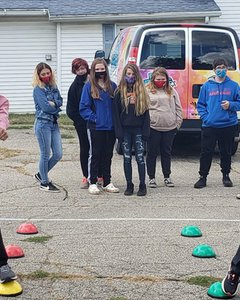 Students watch Regional Superintendent Kyle Thomson, PhD, and SBL Healthy Communities Director Laura Bollan engage in a friendly competition using the new equipment